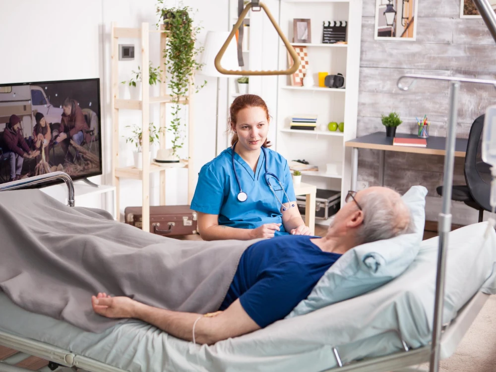 Thrive On Care provides 24-hour care to a man laying in bed with his cell phone.