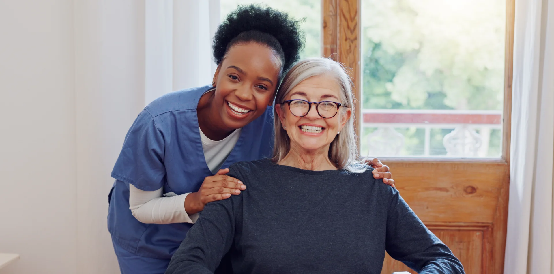 A smiling couple holds documentation after coordinating care with Thrive On Care in Texas.