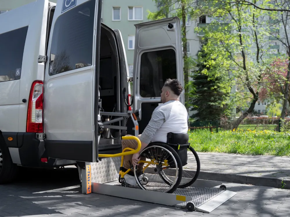 A patient boards a van with help from Thrive On Care’s transportation services.