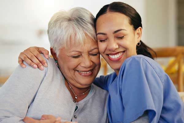 Two women smiling during personal care assistance from Thrive On Care in San Antonio.