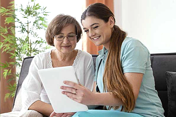 Thrive On Care offers companion care as a woman and a young girl sit together on a couch.