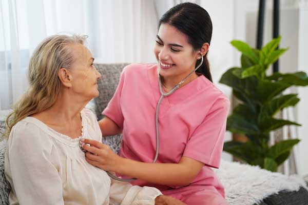 Thrive On Care provides companion care as a woman and a patient sit on a couch.
