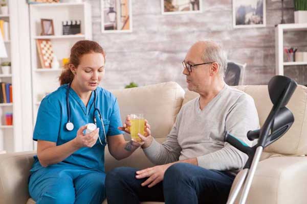Personal care assistance from Thrive On Care supports a woman sitting with a man.