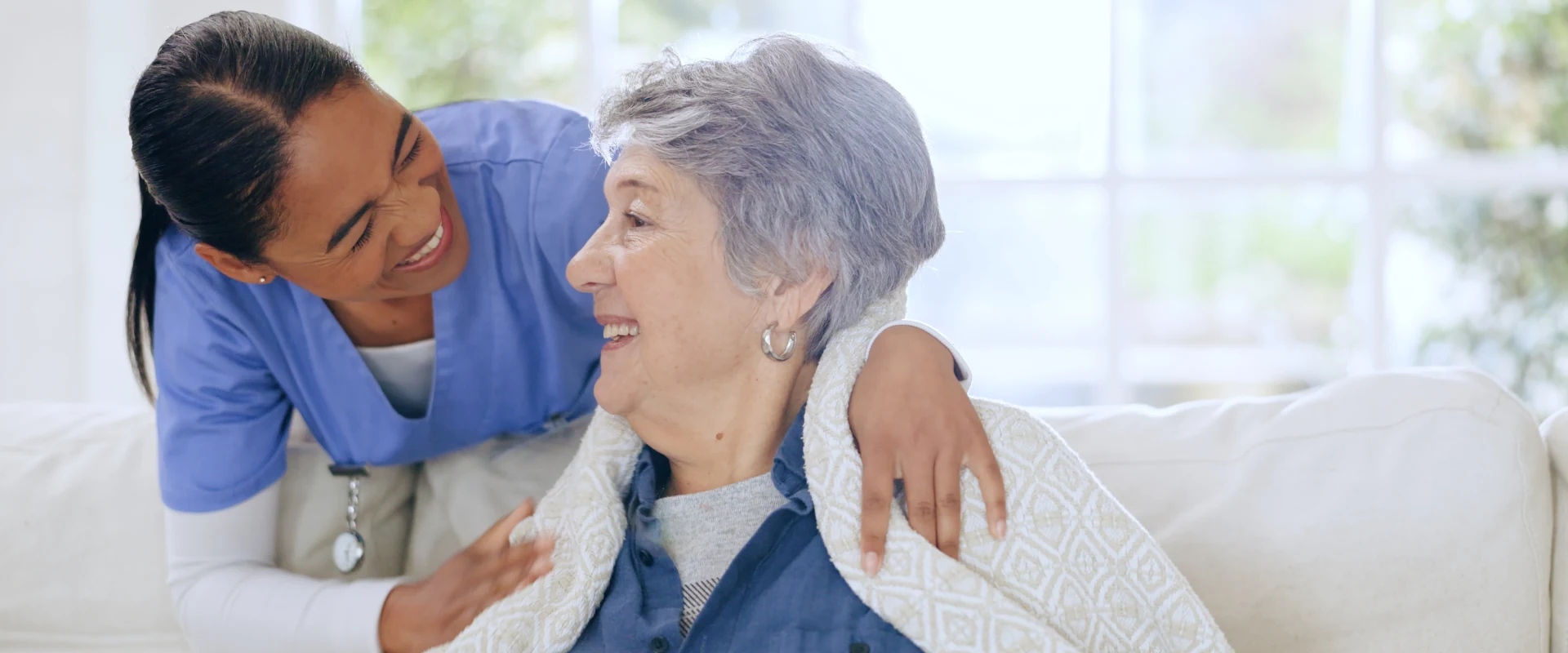 A woman and a patient talk during companion care services from Thrive On Care.