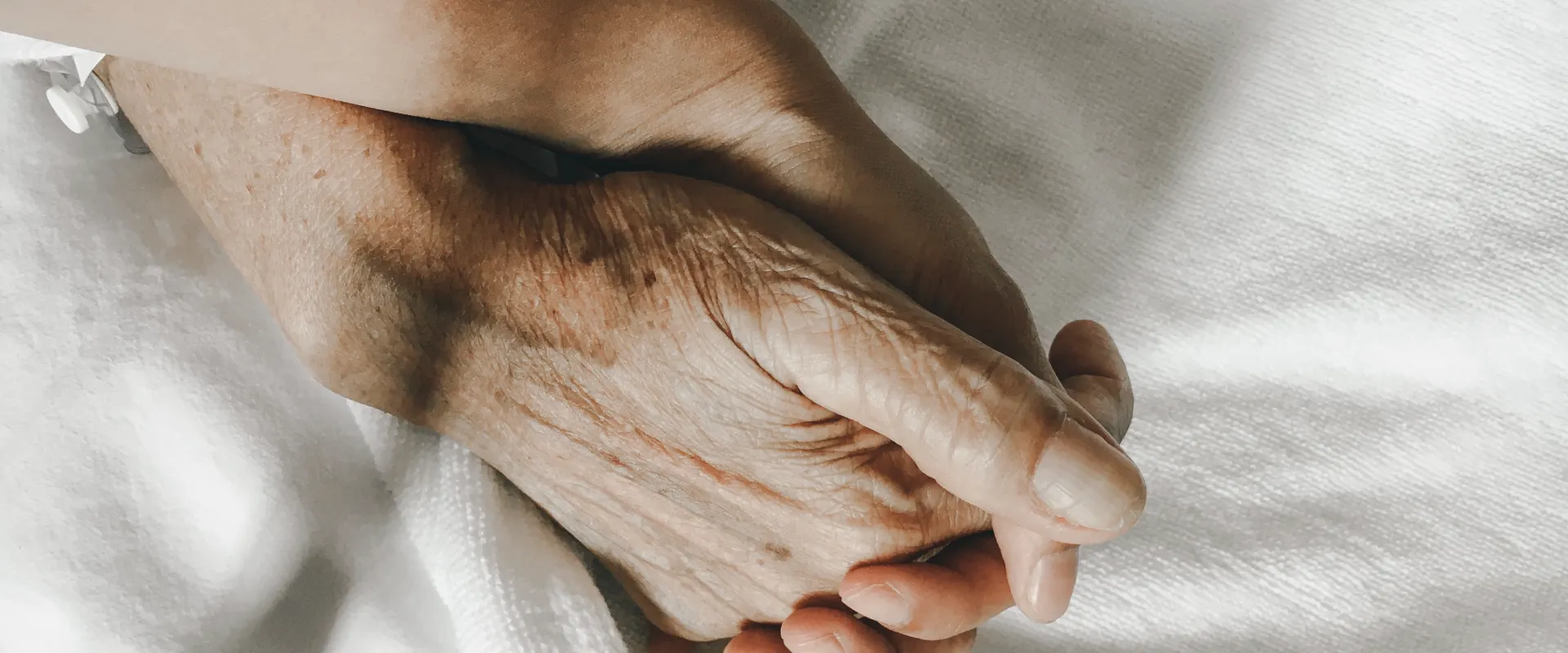 A person holds medication as Thrive On Care assists with reminders and daily care.