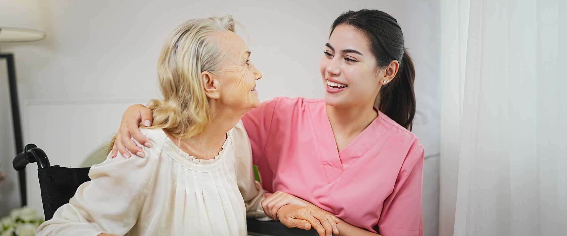 A caregiver from Thrive On Care offers emotional support by gently holding hands with clients.